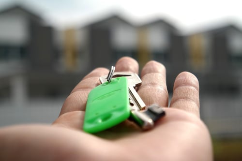 image of a person holding out their hand to receive a set of keys to their apartment