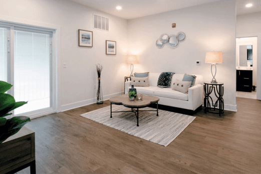 image of the living room of an apartment in Central New Jersey, with lamps, a couch, and coffee table.